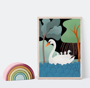 Print of a swan with her cygnets on her back on the water with trees in the background