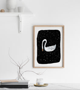 Print of a white swan on black background
