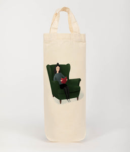 lady in chair reading bottle bag 